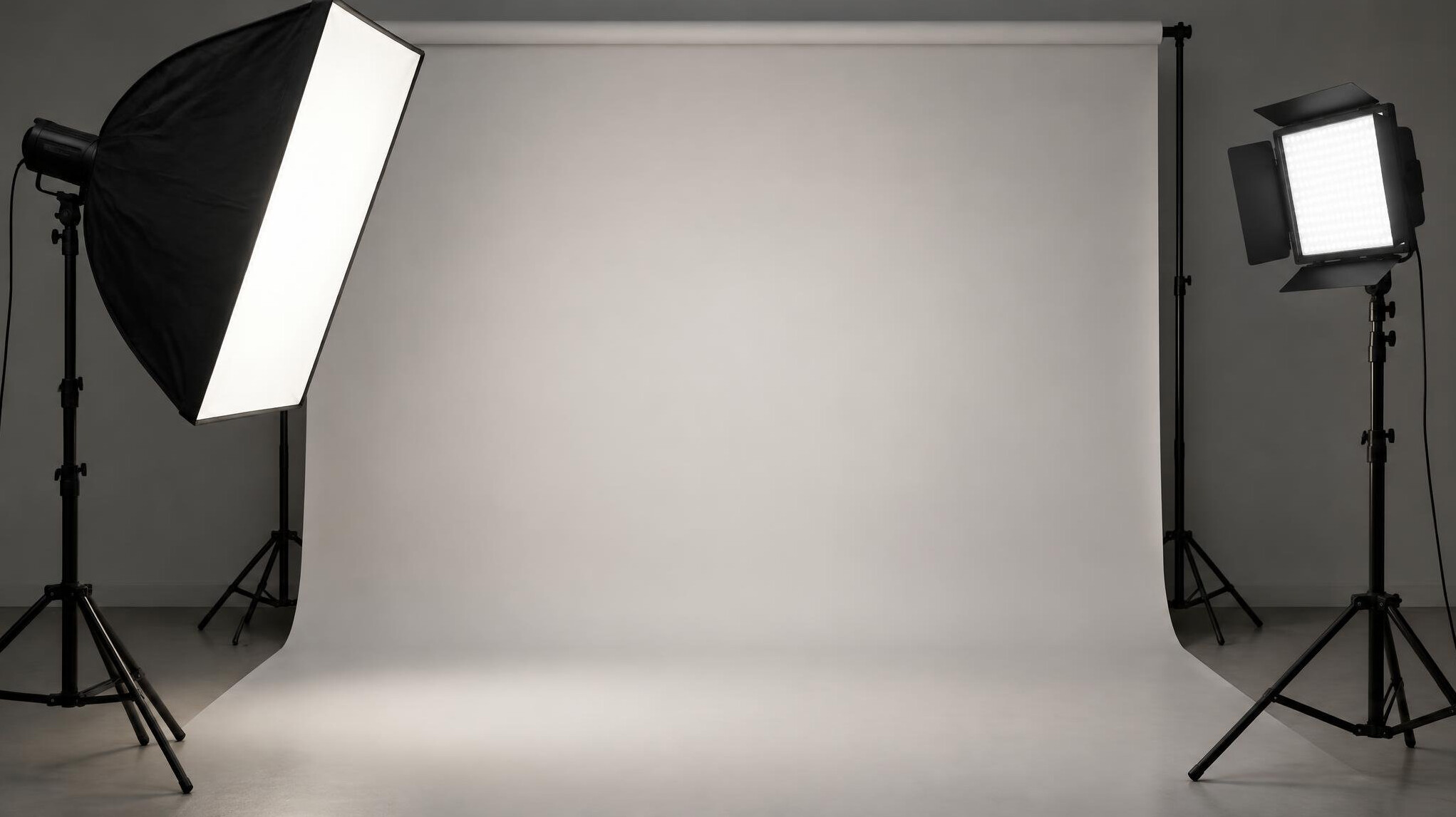 Softbox and LED key light on stands in a studio